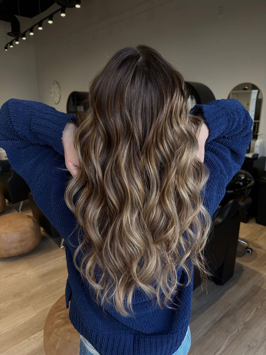 Stylist hand-painting balayage highlights at Shine Beauty & Co. salon in Bismarck, ND